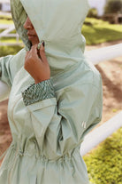 Madame Verde Vol 1 raincoat in light green with hood, stylish waterproof jacket for rainy days in South Africa
