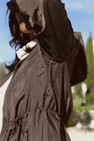 Truffle Haze raincoat in dark brown, lightweight hooded waterproof raincoat ideal for South Africa’s rainy season and wet climate