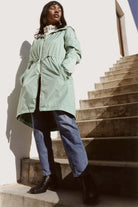 Madame Verde Vol 1 raincoat in light green with hood, stylish waterproof jacket for rainy days in South Africa
