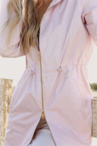 Rosewater Mist raincoat in pastel pink with hood, lightweight waterproof jacket for stylish rainy days in South Africa