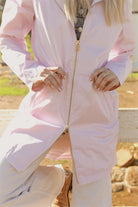 Rosewater Mist raincoat in pastel pink with hood, lightweight waterproof jacket for stylish rainy days in South Africa