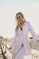 Rosewater Mist raincoat in pastel pink with hood, lightweight waterproof jacket for stylish rainy days in South Africa