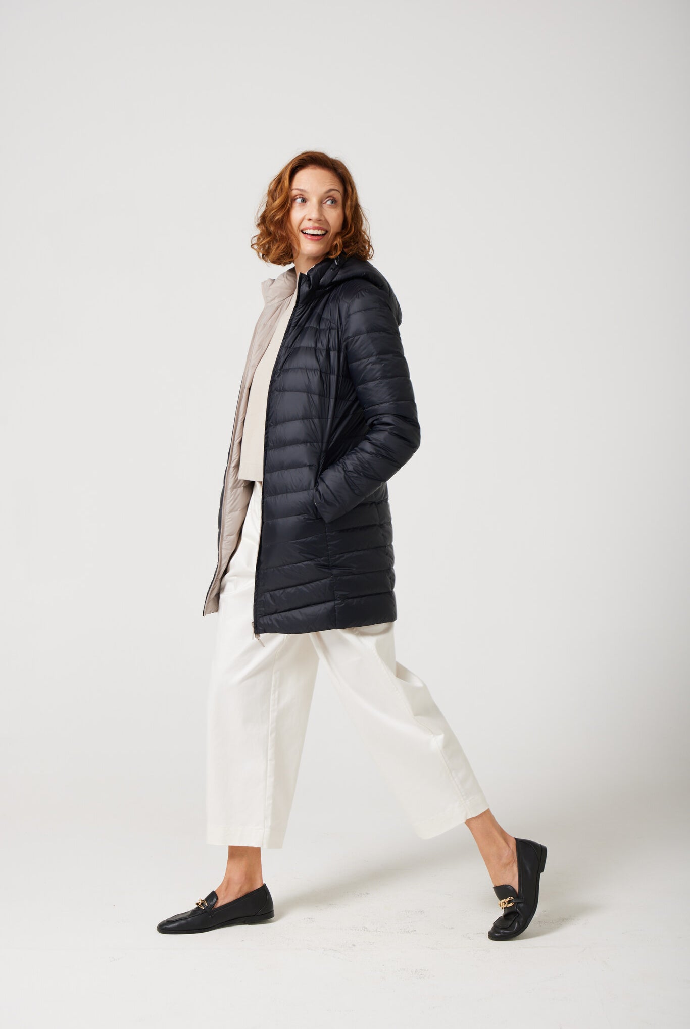 Women’s insulated reversible hooded parka in ebony black and ivory, designed for warmth and comfort in South Africa’s winter season — Ebony x Ivory Classic Parka™