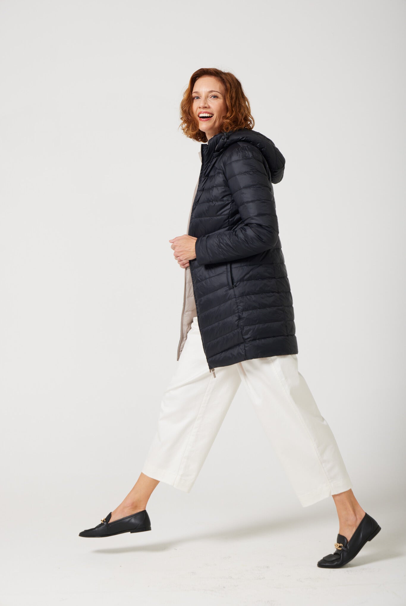 Women’s insulated reversible hooded parka in ebony black and ivory, designed for warmth and comfort in South Africa’s winter season — Ebony x Ivory Classic Parka™