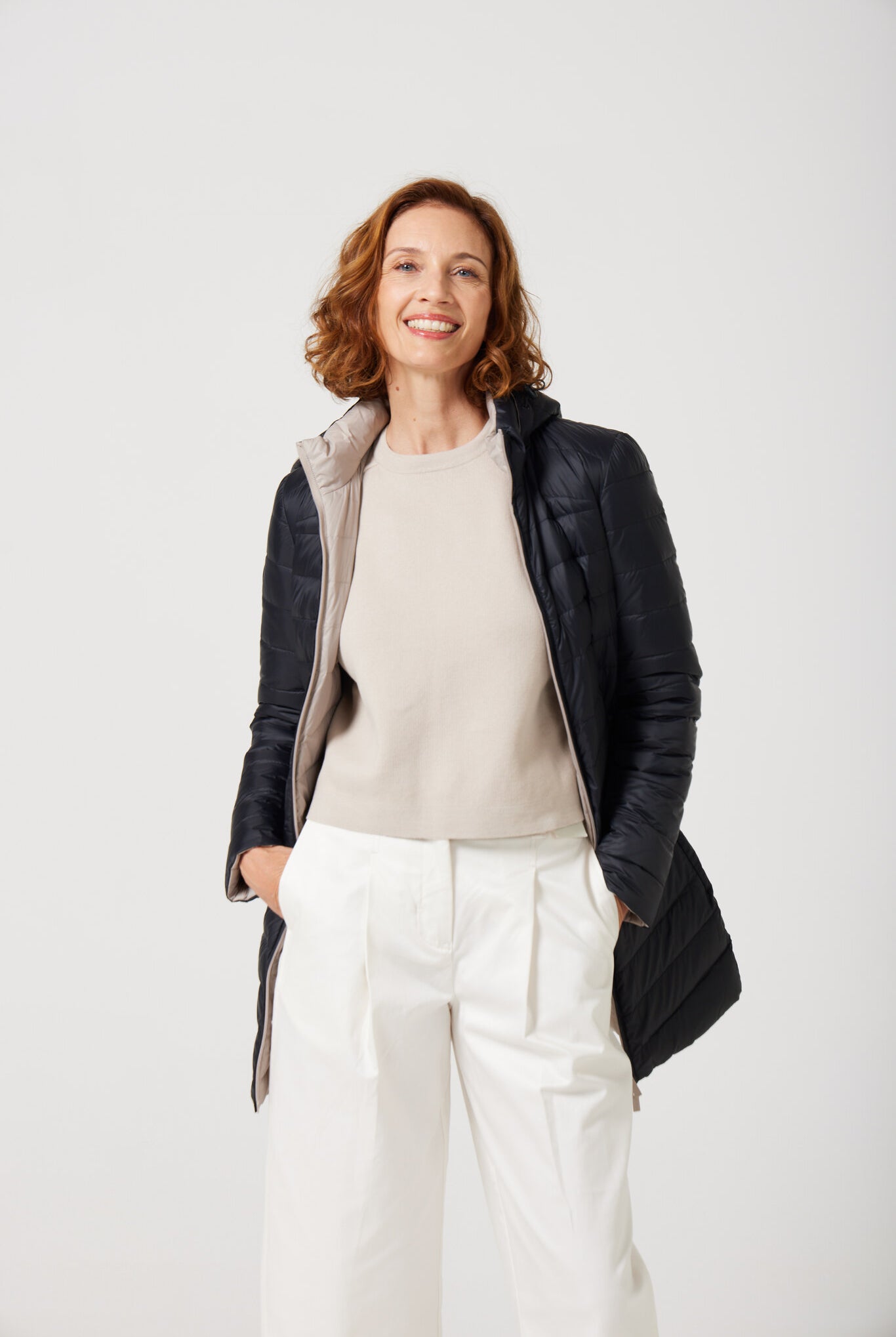 Women’s insulated reversible hooded parka in ebony black and ivory, designed for warmth and comfort in South Africa’s winter season — Ebony x Ivory Classic Parka™