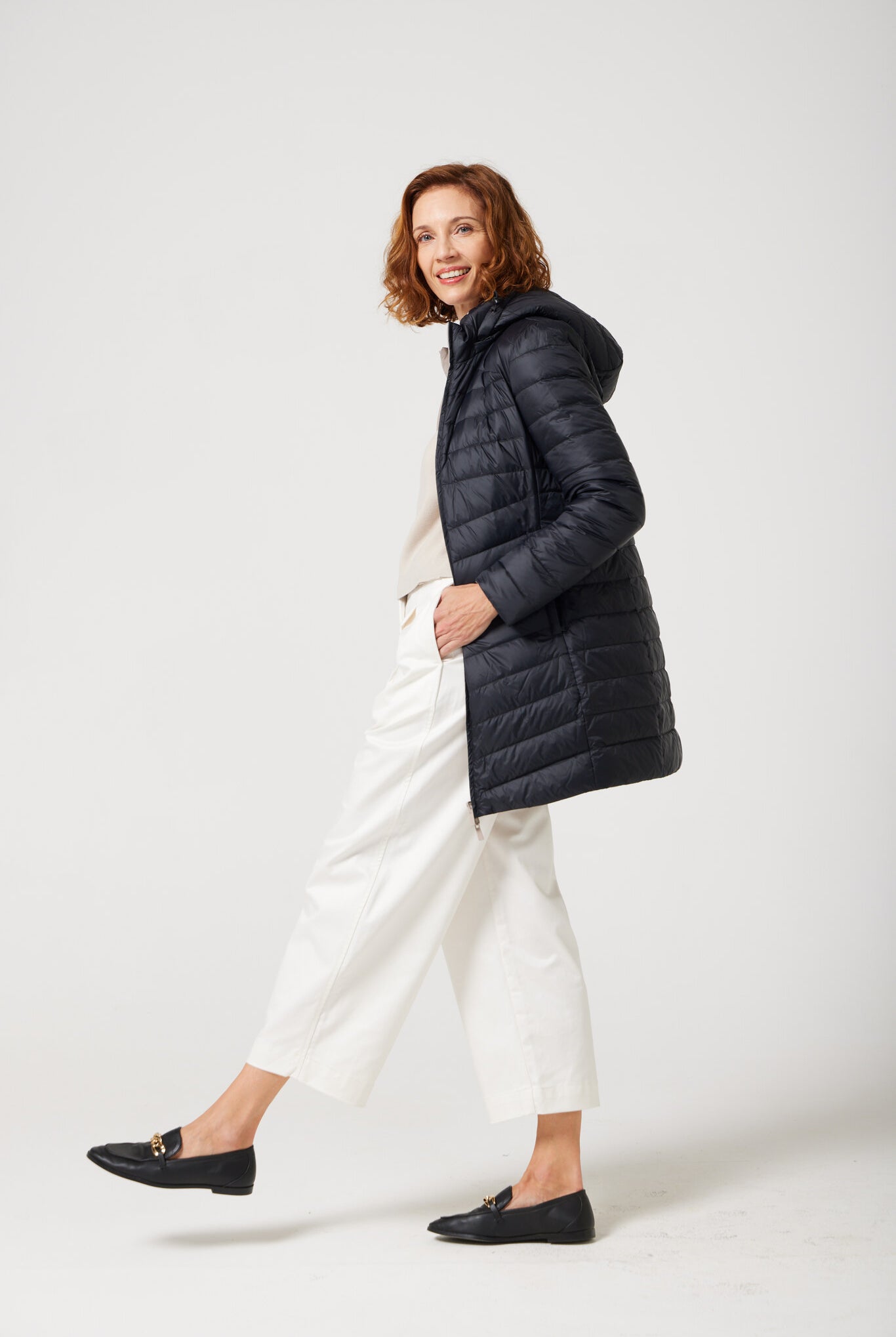 Women’s insulated reversible hooded parka in ebony black and ivory, designed for warmth and comfort in South Africa’s winter season — Ebony x Ivory Classic Parka™