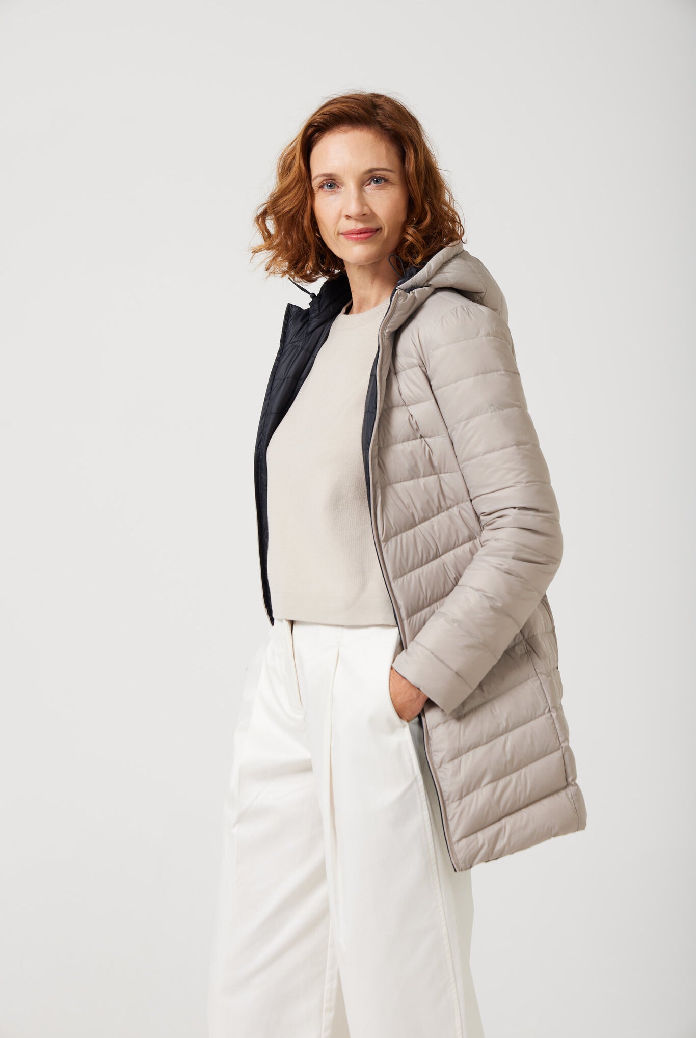 Women’s insulated reversible hooded parka in ebony black and ivory, designed for warmth and comfort in South Africa’s winter season — Ebony x Ivory Classic Parka™