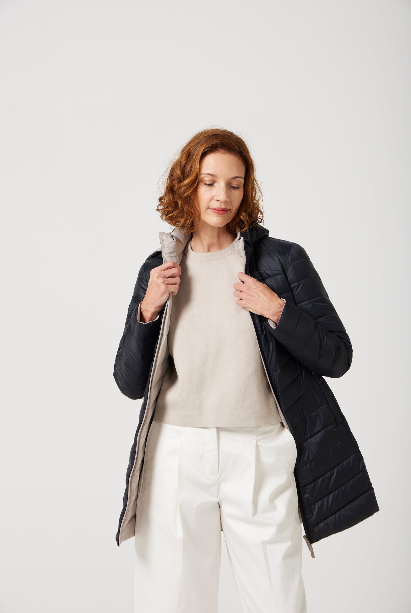 Women’s insulated reversible hooded parka in ebony black and ivory, designed for warmth and comfort in South Africa’s winter season — Ebony x Ivory Classic Parka™