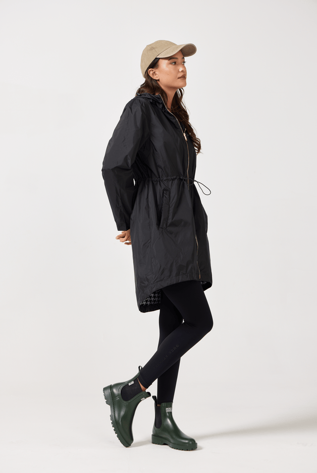 The Highland Midnight raincoat in classic black, lightweight hooded waterproof raincoat ideal for South Africa’s rainy season and wet climate