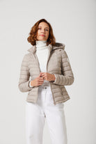 Women’s Latte Classic Jacket™ in a soft beige shade, lightweight puffer jacket with hood, perfect for layering during cool South African weather