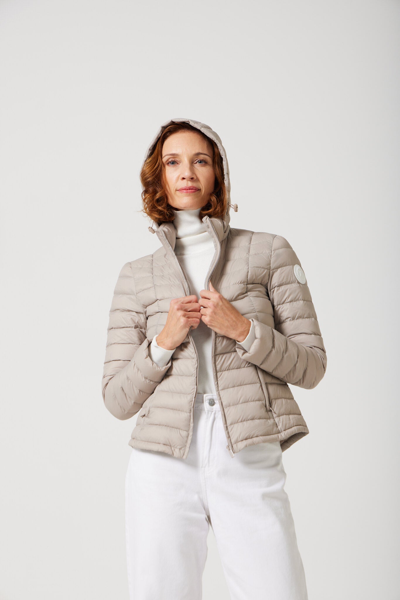 Women’s Latte Classic Jacket™ in a soft beige shade, lightweight puffer jacket with hood, perfect for layering during cool South African weather
