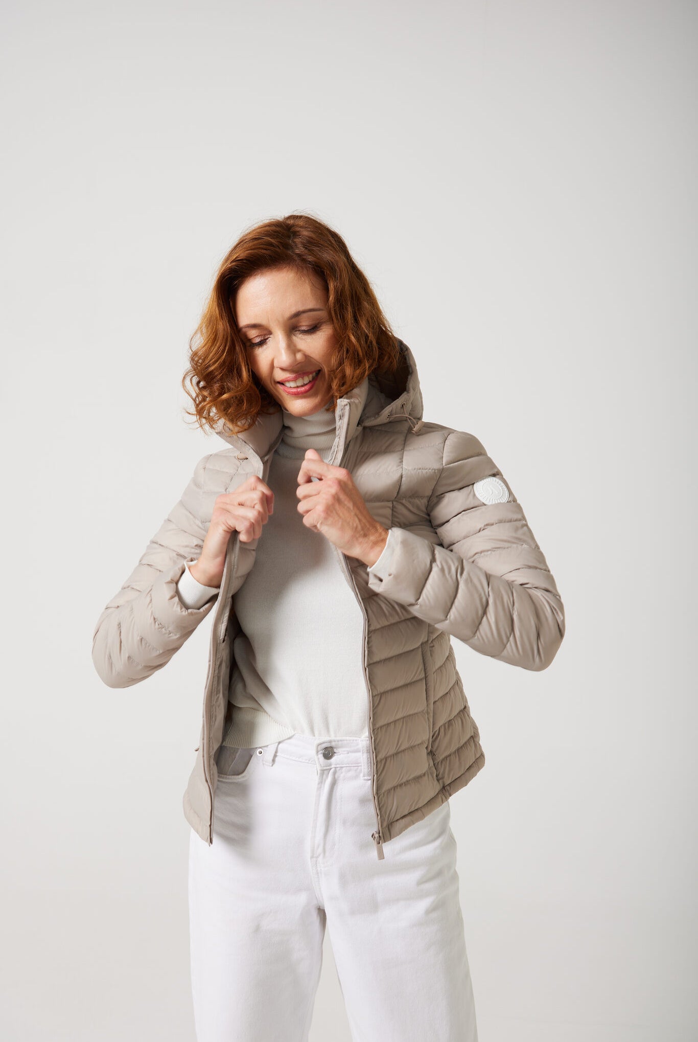 Women’s Latte Classic Jacket™ in a soft beige shade, lightweight puffer jacket with hood, perfect for layering during cool South African weather