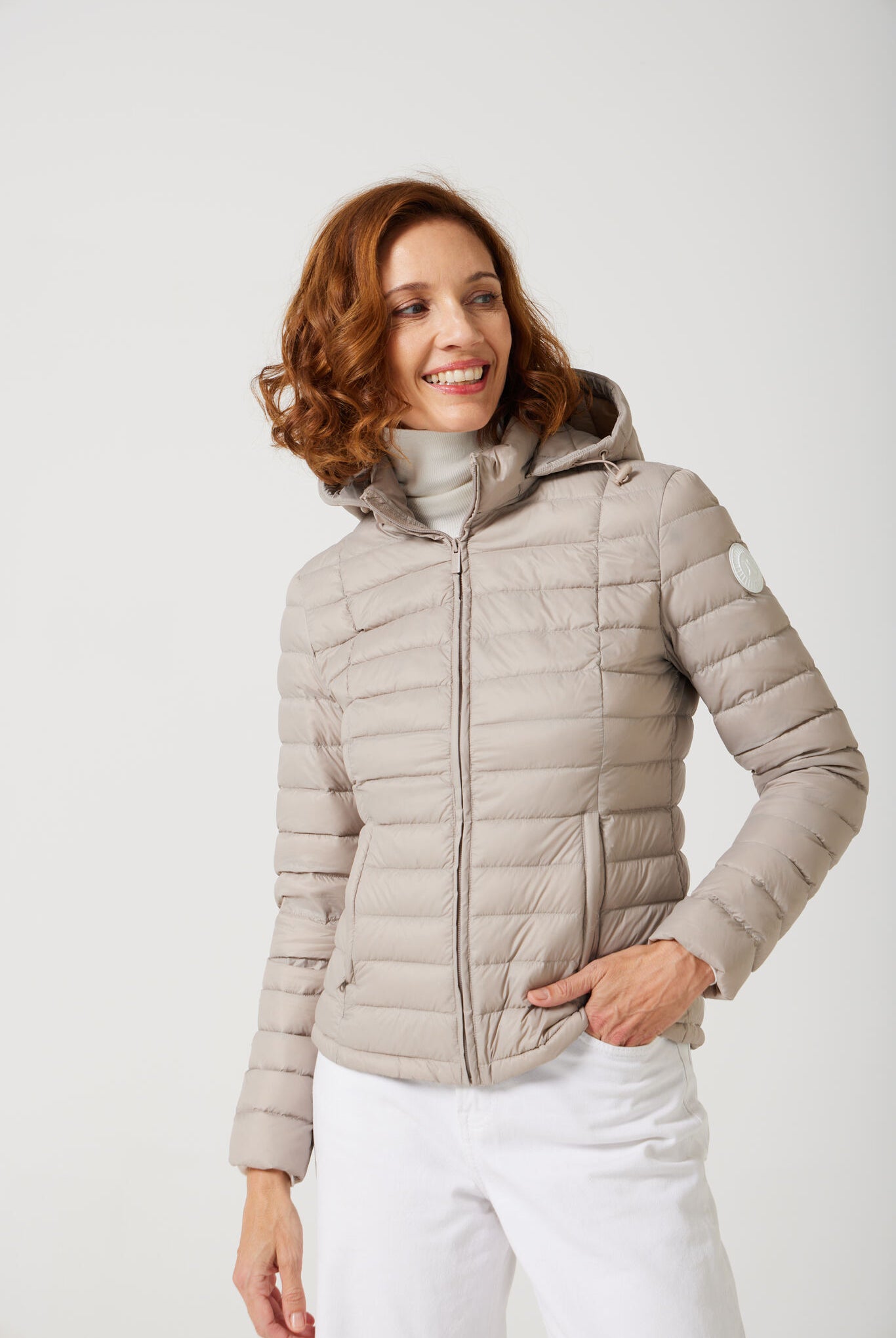 Women’s Latte Classic Jacket™ in a soft beige shade, lightweight puffer jacket with hood, perfect for layering during cool South African weather