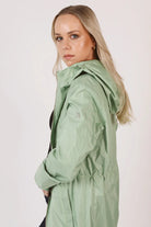 Madame Verde Vol 1 raincoat in light green with hood, stylish waterproof jacket for rainy days in South Africa