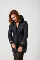 Women’s insulated reversible hooded parka in leopard print and midnight black, designed for warmth and comfort in South Africa’s winter season — Midnight x Leopard Classic Parka™