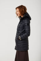 Women’s insulated reversible hooded parka in leopard print and midnight black, designed for warmth and comfort in South Africa’s winter season — Midnight x Leopard Classic Parka™