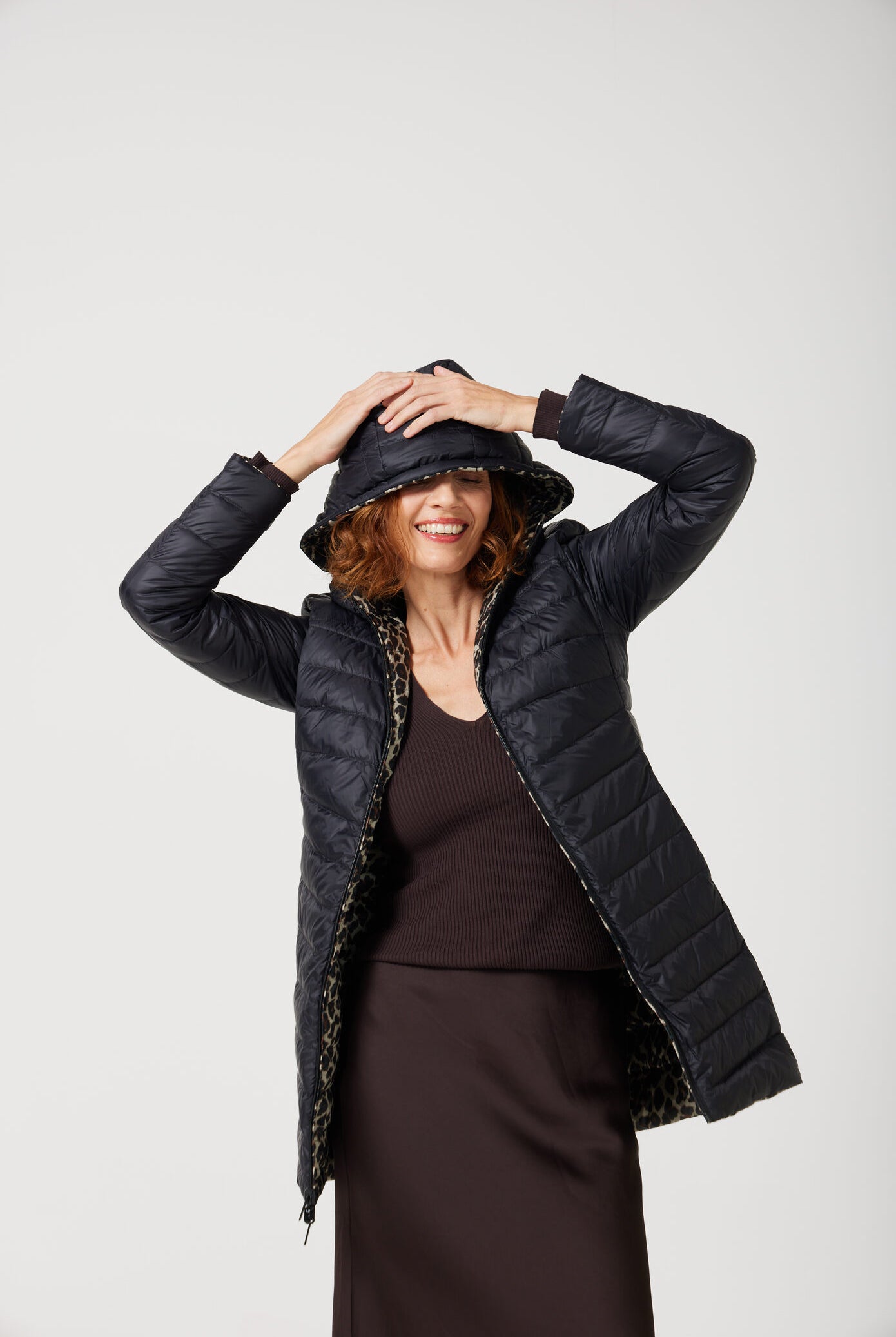 Women’s insulated reversible hooded parka in leopard print and midnight black, designed for warmth and comfort in South Africa’s winter season — Midnight x Leopard Classic Parka™