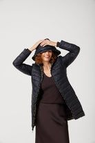 Women’s insulated reversible hooded parka in leopard print and midnight black, designed for warmth and comfort in South Africa’s winter season — Midnight x Leopard Classic Parka™