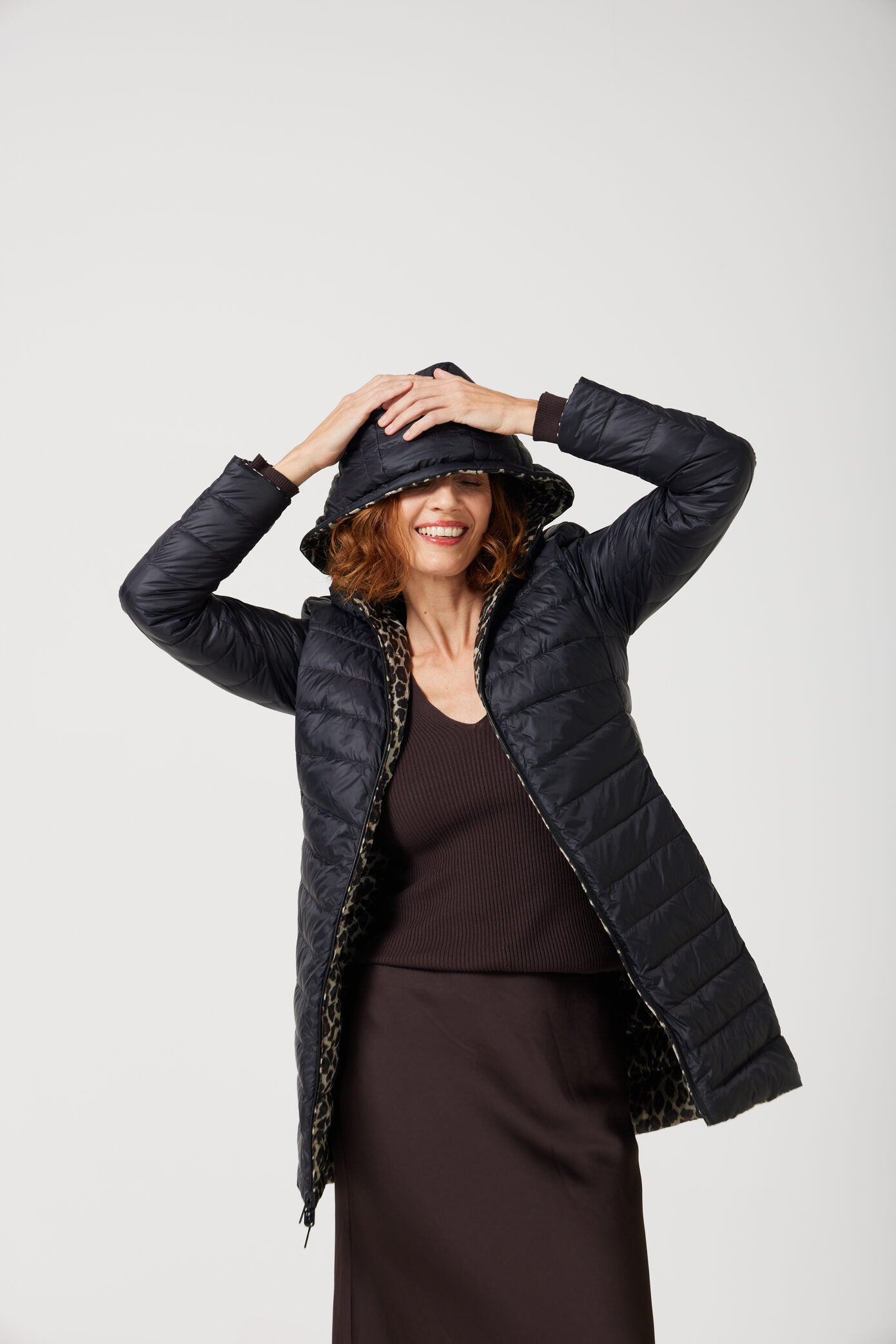 Women’s insulated reversible hooded parka in leopard print and midnight black, designed for warmth and comfort in South Africa’s winter season — Midnight x Leopard Classic Parka™