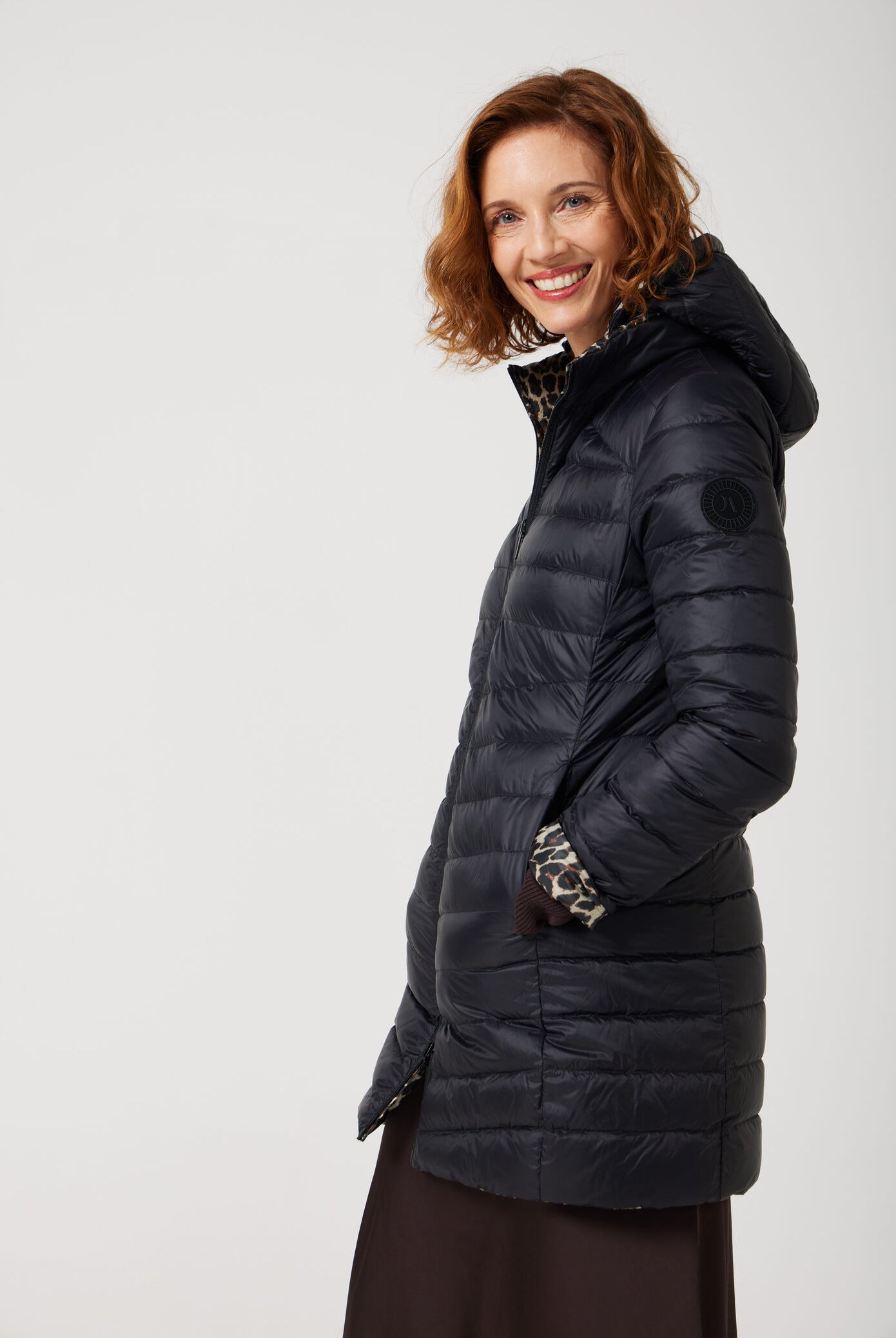Women’s insulated reversible hooded parka in leopard print and midnight black, designed for warmth and comfort in South Africa’s winter season — Midnight x Leopard Classic Parka™