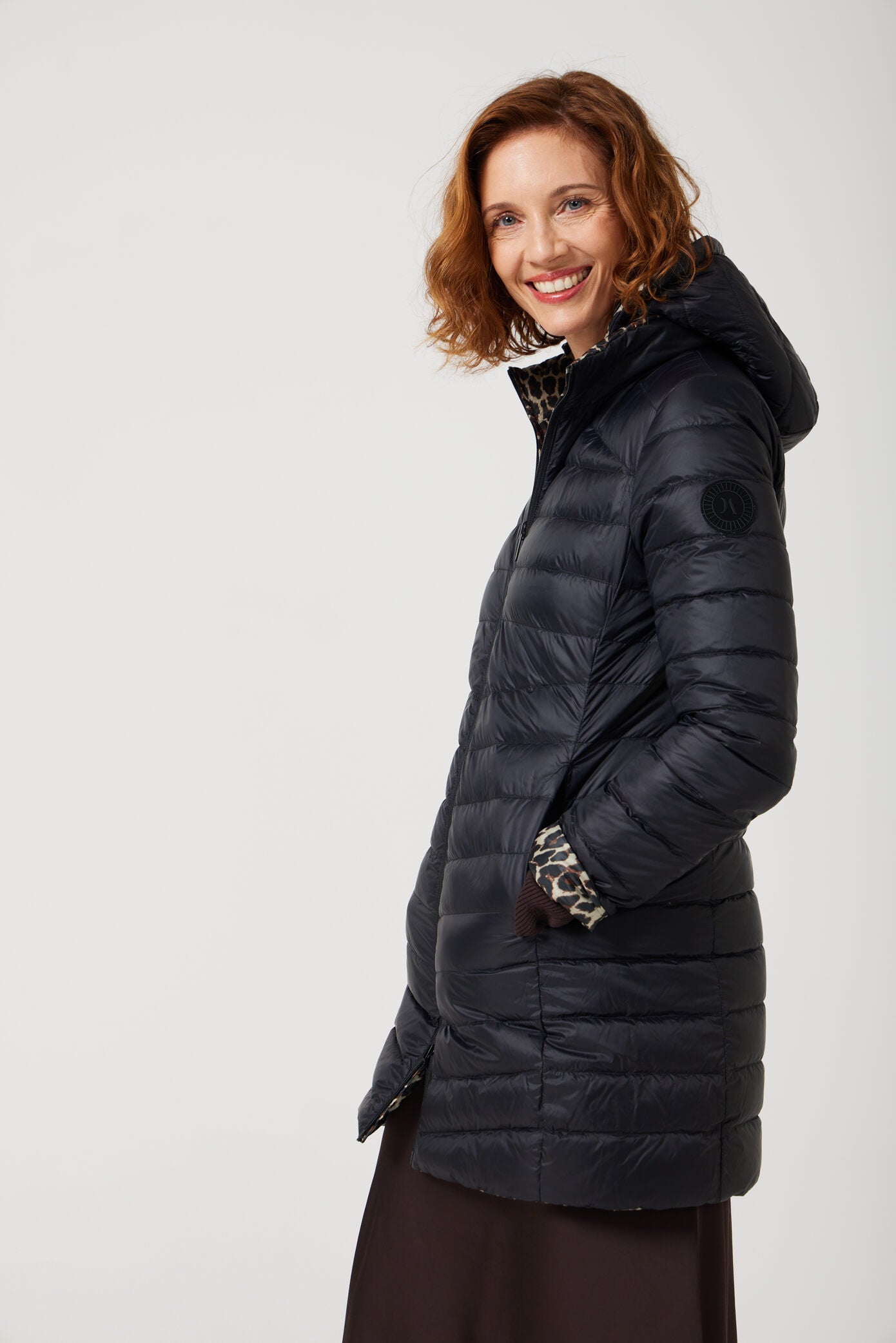 Women’s insulated reversible hooded parka in leopard print and midnight black, designed for warmth and comfort in South Africa’s winter season — Midnight x Leopard Classic Parka™