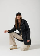 The Highland Midnight raincoat in classic black, lightweight hooded waterproof raincoat ideal for South Africa’s rainy season and wet climate