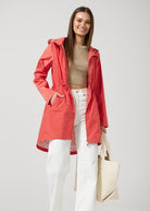 The Coral Spritz raincoat in coral red, lightweight hooded waterproof raincoat ideal for South Africa’s rainy season and wet climate