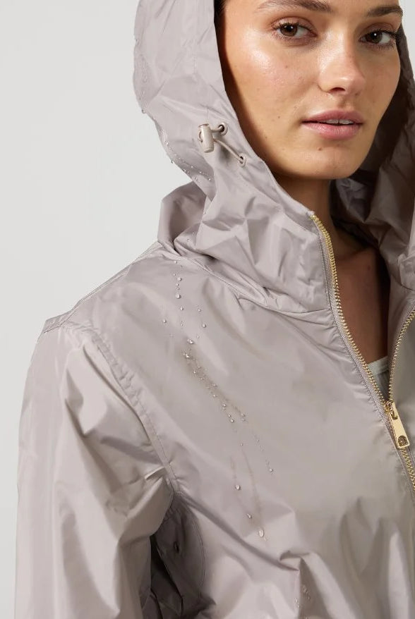 The Cairo Sands raincoat in beige, lightweight hooded waterproof raincoat ideal for South Africa’s rainy season and wet climate