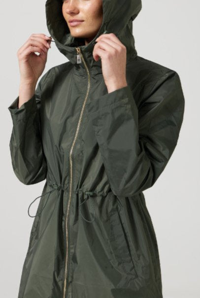 The Juniper raincoat in deep green, lightweight hooded waterproof raincoat ideal for South Africa’s rainy season and wet climate