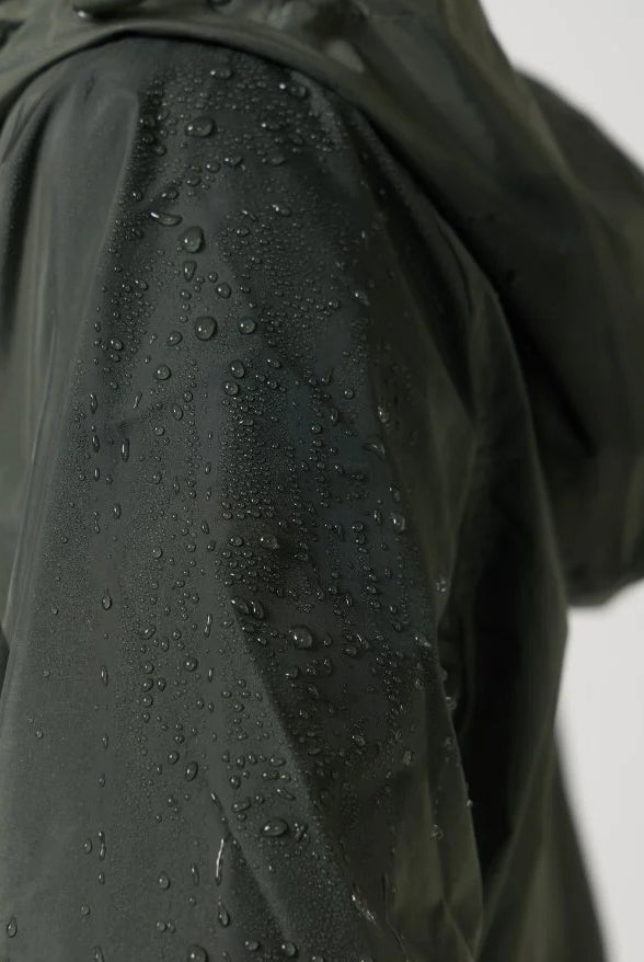 The Juniper raincoat in deep green, lightweight hooded waterproof raincoat ideal for South Africa’s rainy season and wet climate