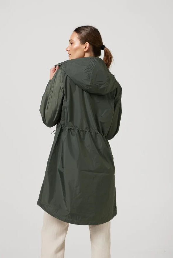 The Juniper raincoat in deep green, lightweight hooded waterproof raincoat ideal for South Africa’s rainy season and wet climate