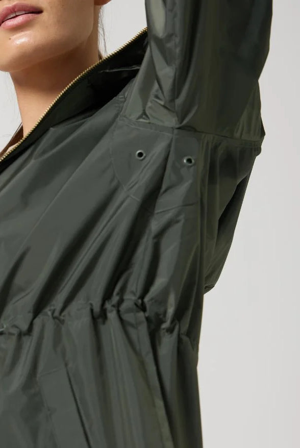 The Juniper raincoat in deep green, lightweight hooded waterproof raincoat ideal for South Africa’s rainy season and wet climate
