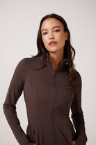 Brown Lightweight performance jacket with a smooth, sculpting fit, full zip front, high collar, and stretch fabric designed for everyday movement and layering.