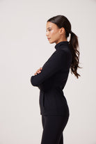 Black Lightweight performance jacket with a smooth, sculpting fit, full zip front, high collar, and stretch fabric designed for everyday movement and layering.