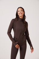 Brown Lightweight performance jacket with a smooth, sculpting fit, full zip front, high collar, and stretch fabric designed for everyday movement and layering.