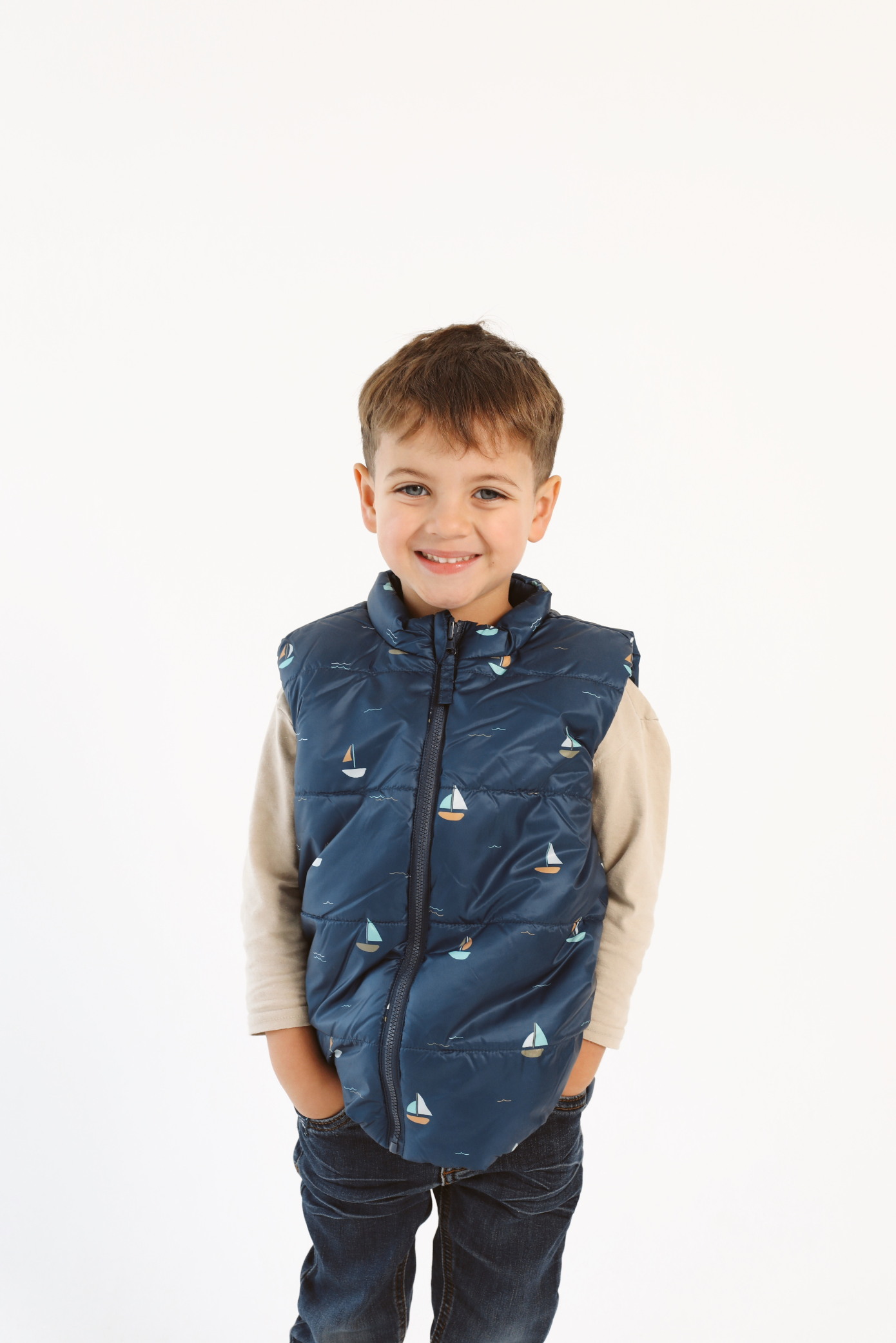 Kids Boats x Navy Gilet™ — sleeveless navy puffer vest with playful boat print, a versatile layer for kids in South Africa