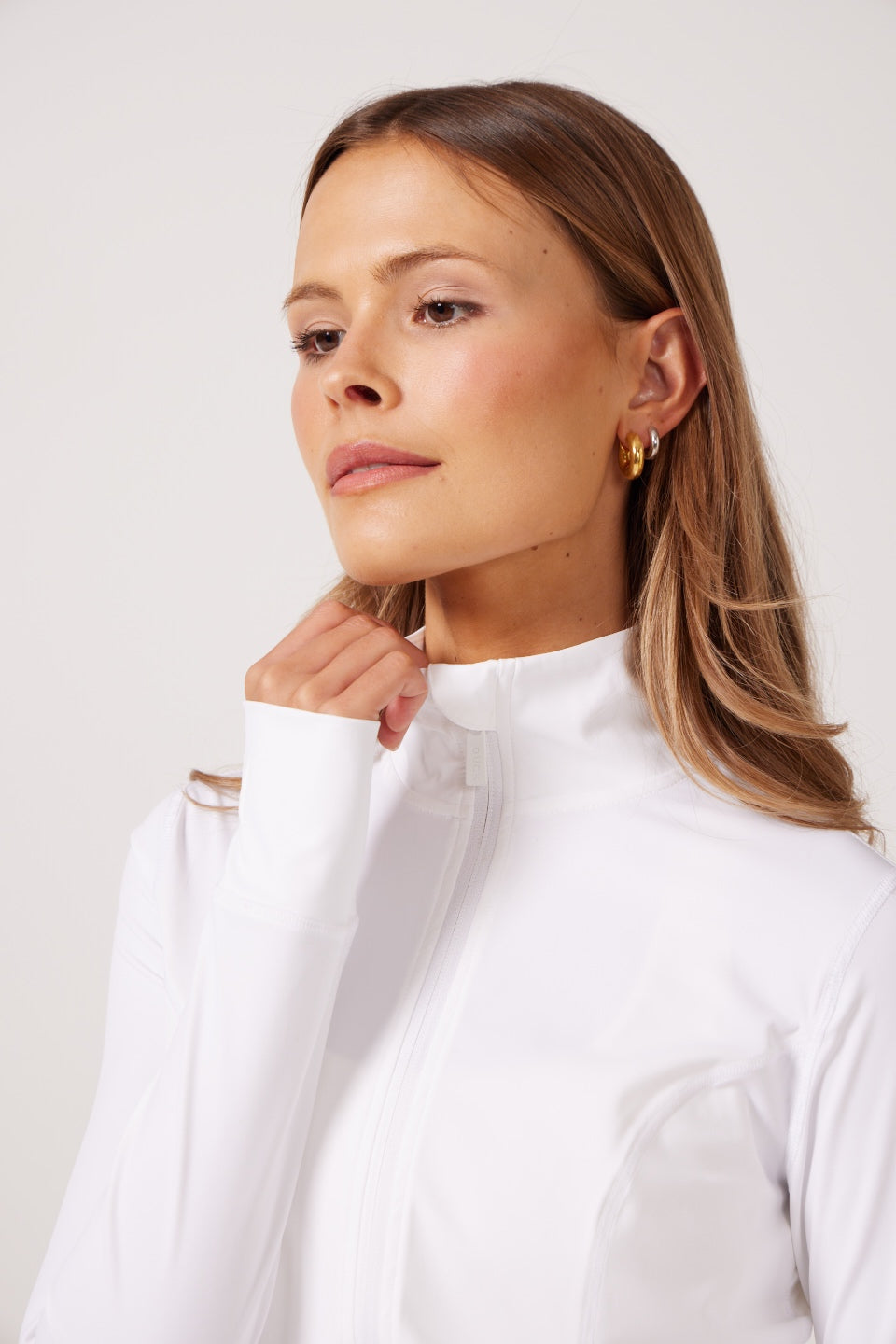 White Lightweight performance jacket with a smooth, sculpting fit, full zip front, high collar, and stretch fabric designed for everyday movement and layering.