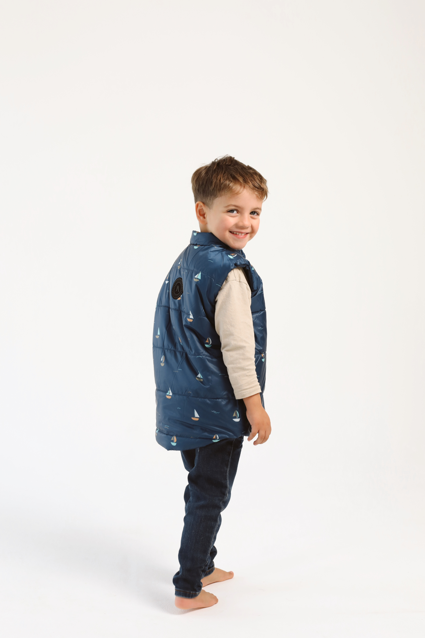 Kids Boats x Navy Gilet™ — sleeveless navy puffer vest with playful boat print, a versatile layer for kids in South Africa
