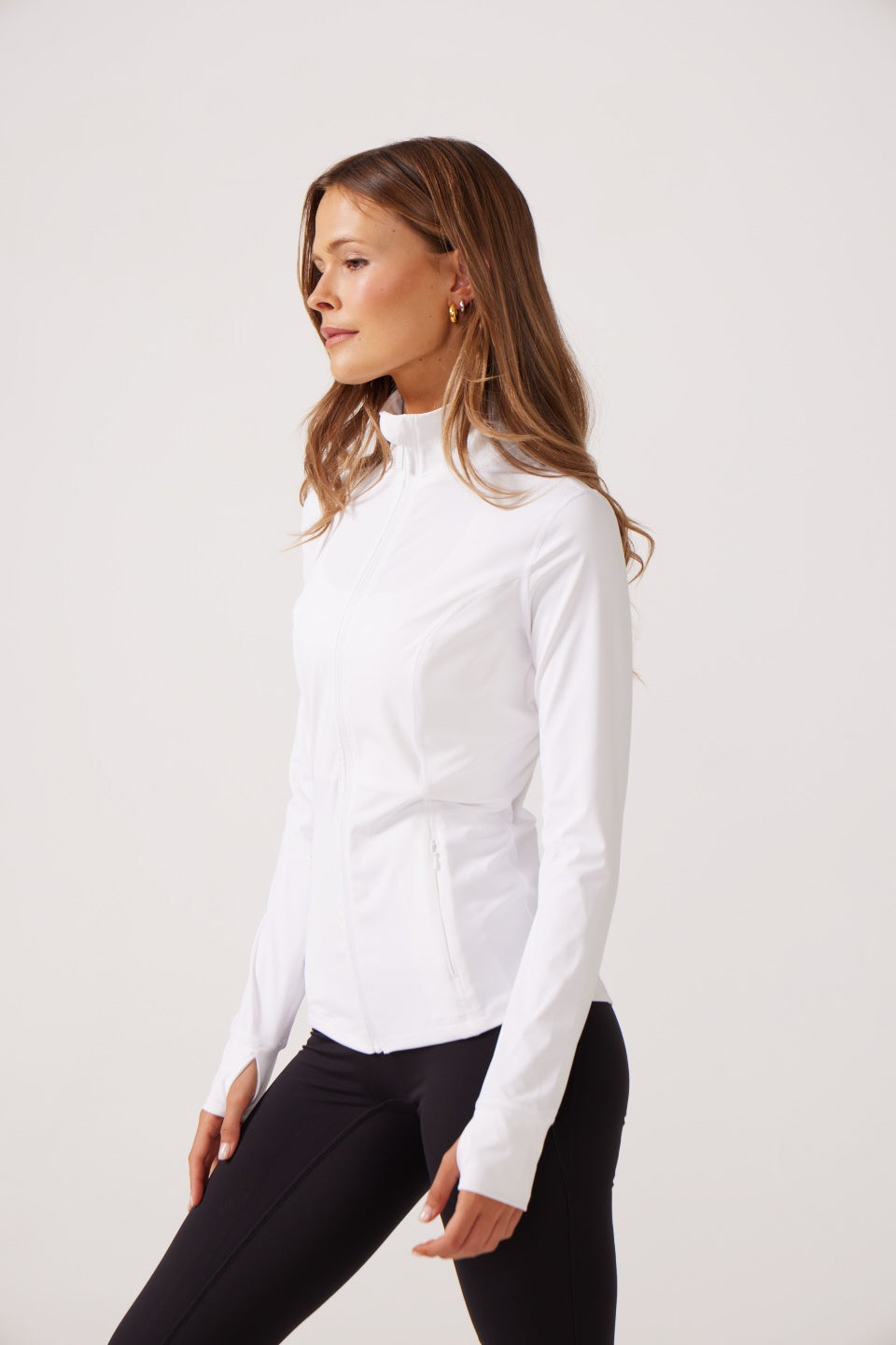 White Lightweight performance jacket with a smooth, sculpting fit, full zip front, high collar, and stretch fabric designed for everyday movement and layering.