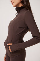 Brown Lightweight performance jacket with a smooth, sculpting fit, full zip front, high collar, and stretch fabric designed for everyday movement and layering.