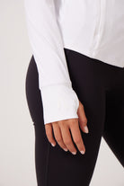 White Lightweight performance jacket with a smooth, sculpting fit, full zip front, high collar, and stretch fabric designed for everyday movement and layering.