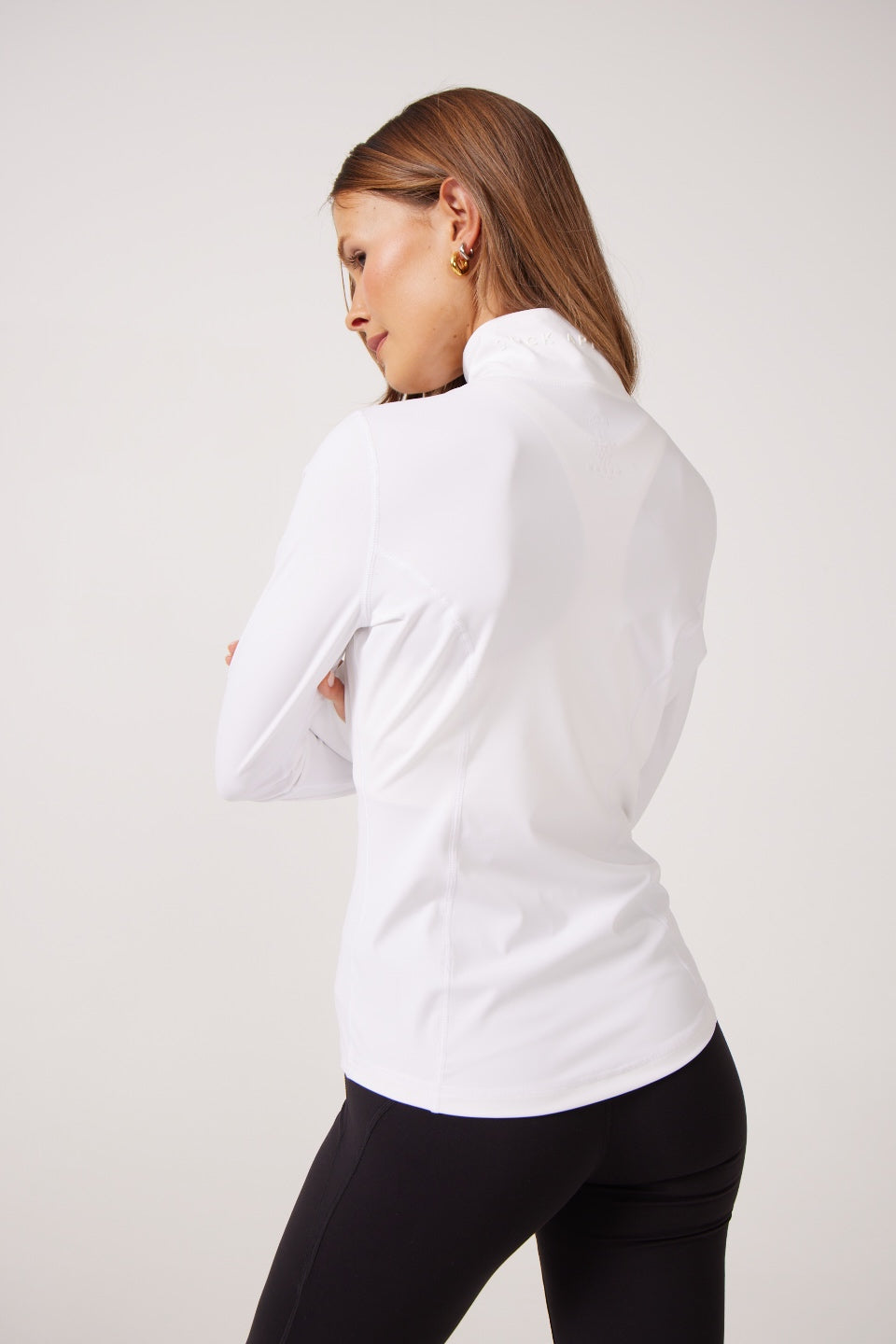 White Lightweight performance jacket with a smooth, sculpting fit, full zip front, high collar, and stretch fabric designed for everyday movement and layering.