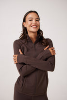 Brown Lightweight performance jacket with a smooth, sculpting fit, full zip front, high collar, and stretch fabric designed for everyday movement and layering.