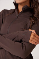 Brown Lightweight performance jacket with a smooth, sculpting fit, full zip front, high collar, and stretch fabric designed for everyday movement and layering.