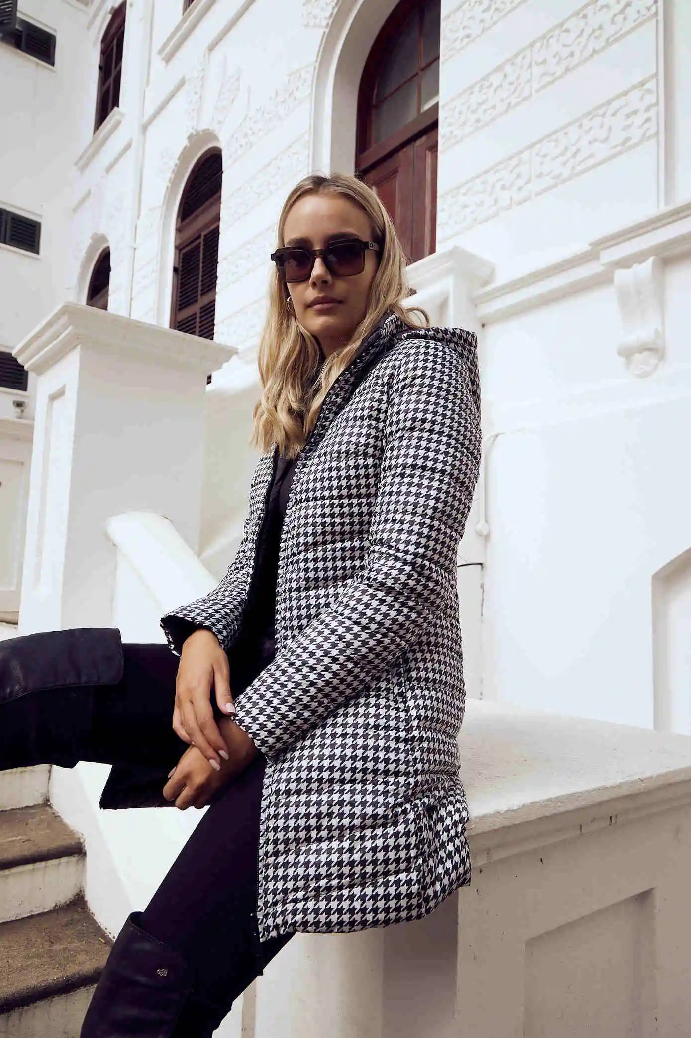 Women’s insulated reversible hooded parka in houndstooth print and midnight black, designed for warmth and comfort in South Africa’s winter season — Midnight x Houndstooth Classic Parka™