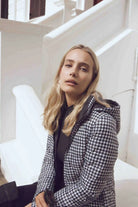 Women’s insulated reversible hooded parka in houndstooth print and midnight black, designed for warmth and comfort in South Africa’s winter season — Midnight x Houndstooth Classic Parka™