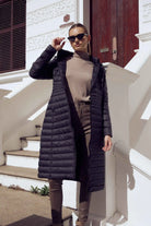 Women’s insulated ultra-length hooded parka in midnight black, designed for extra warmth and comfort in South Africa’s winter season — Midnight Ultra Parka™