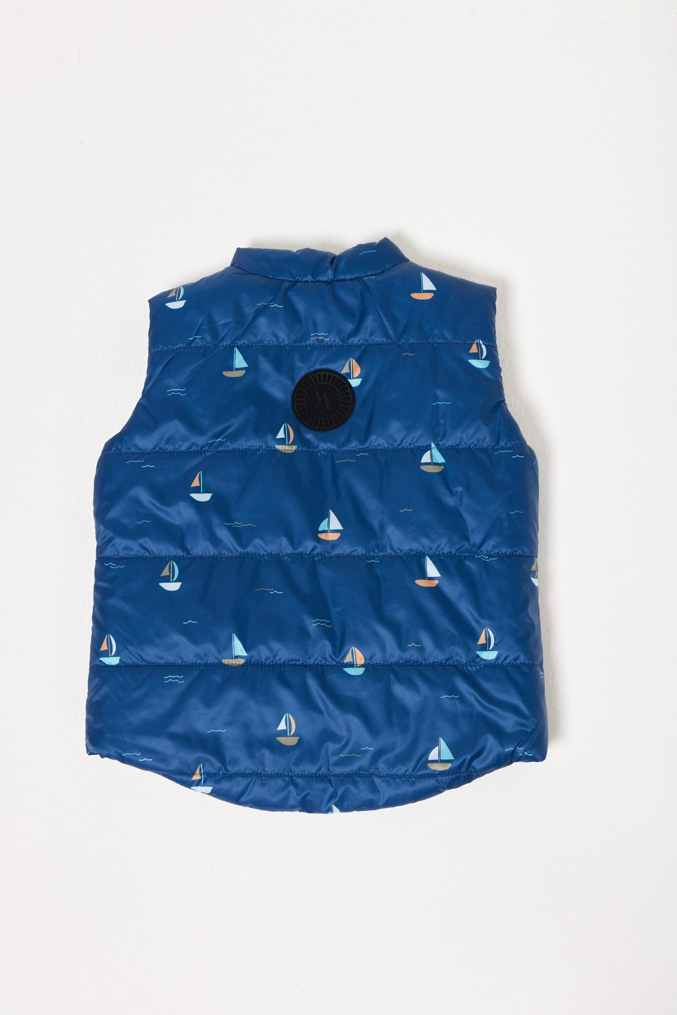 Kids Boats x Navy Gilet™ — sleeveless navy puffer vest with playful boat print, a versatile layer for kids in South Africa