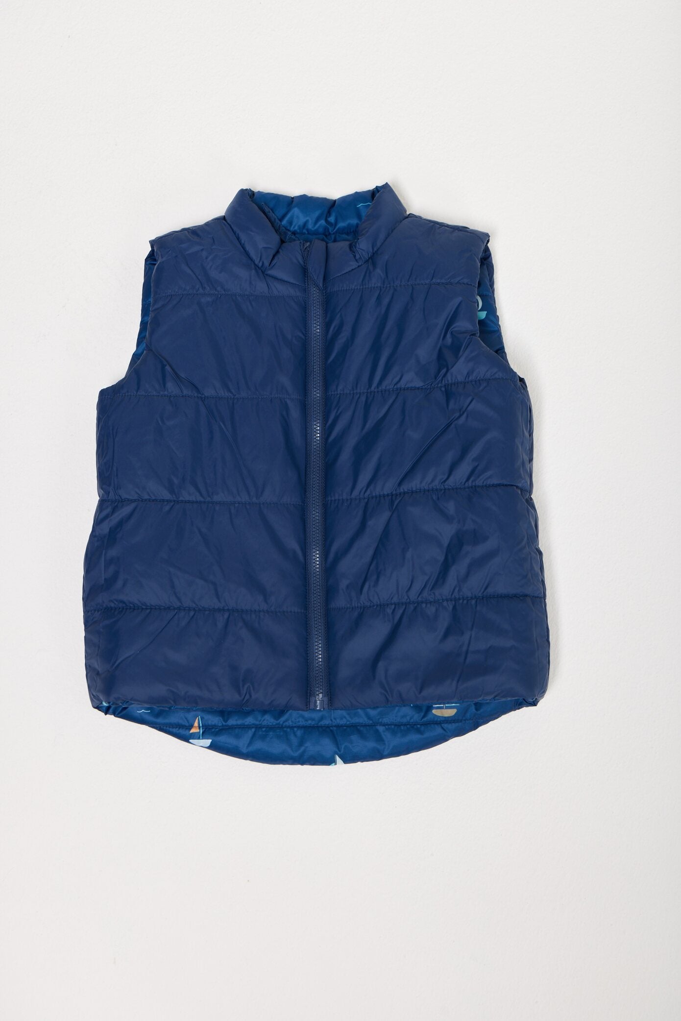Kids Boats x Navy Gilet™ — sleeveless navy puffer vest with playful boat print, a versatile layer for kids in South Africa
