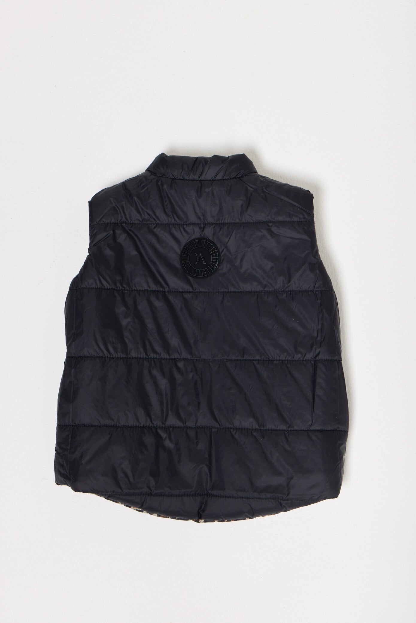 Kids Leopard x Black Gilet™ — sleeveless kids’ puffer vest in bold leopard print with black accents, a fun winter essential in South Africa